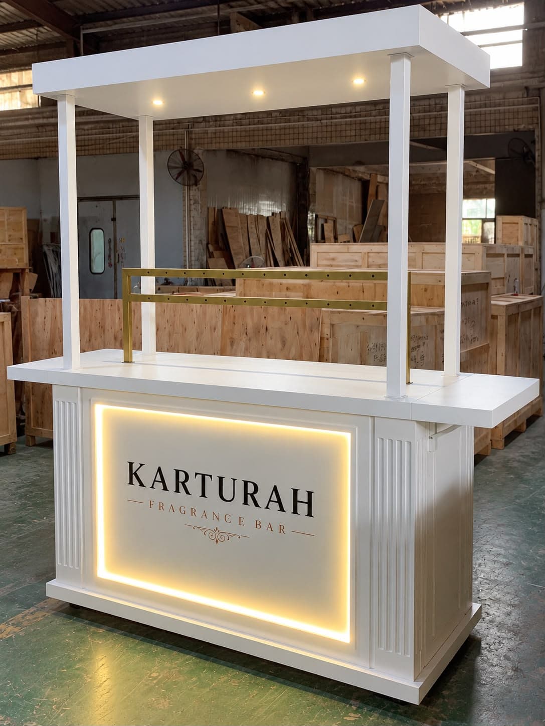 The Karturah Fragrance Bar, with a white canopy, gold rail and illuminated brand panel